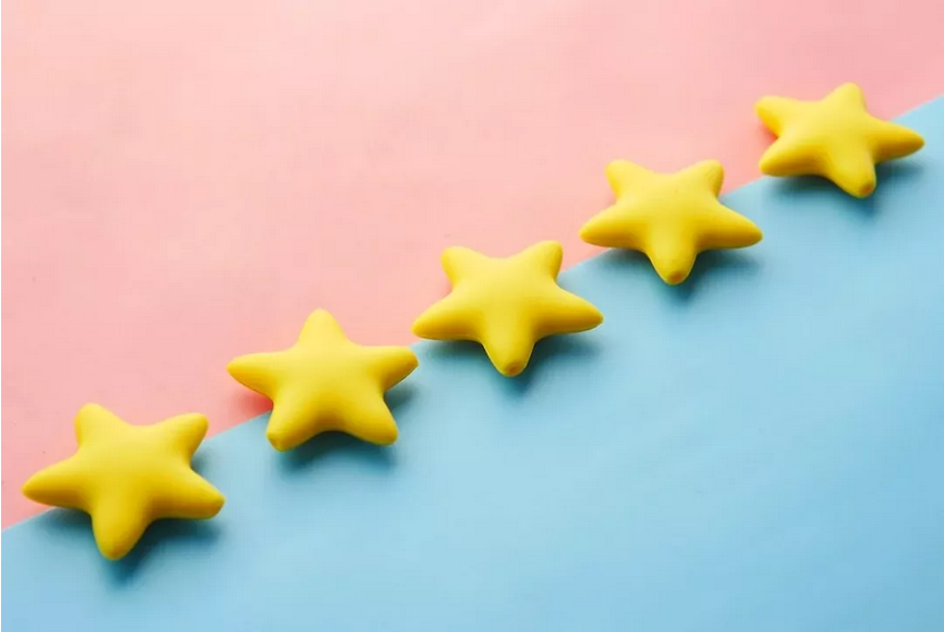an image of six yellow stars diagonally on a blue and pink background